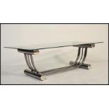 A contemporary 20th century glass and chrome coffee - occasional table. The chrome tubular base of