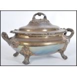 A late 19th Century silver plated lidded terrine in the Rococo taste, raised on four scrolled feet