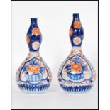 A pair of 19th century Japanese Imari gourd vases having hand painted decoration. Measures 20cm-high