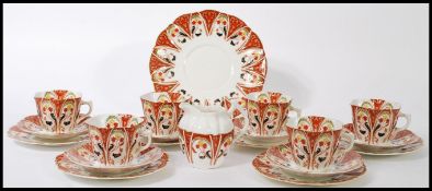 An early 20th century Wellington China six person tea service consisting of six cup, saucer and side