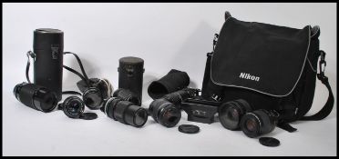 A collection of vintage 20th Century camera lenses to include a SMC Pentax 1:3.5, Vivitar Series 1
