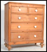 A Victorian 19th century pine chest of drawers being raised on turned legs with a configuration of 2