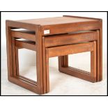 A vintage / retro 20th Century teak wood nest of three graduating tables, square tops raised on