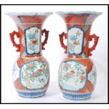 A pair of early 20th Century Japanese hand painted Imari vases, with bulbous bases and trumpet