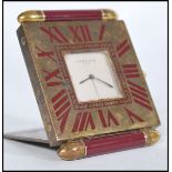 A vintage 20th century Cartier Paris travel desk clock having white enamel signed face with brass