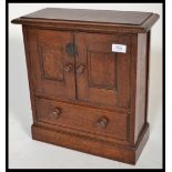 A Victorian carved oak smokers table top cabinet b