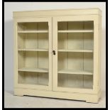 A late 19th century glazed library bookcase display cabinet. Twin glazed doors with fitted wooden
