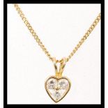 A hallmarked 18ct gold fine curb link necklace chain having an 18ct gold and diamond pendant. Approx