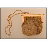 A 9ct gold ladies mesh purse having a yellow metal test as 9ct gold chain. Gross weight 38.8.