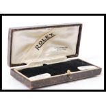 A vintage 20th century Rolex watch box having a leatherette covering with gilt tooled decoration.