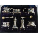 A cased seven piece silver hallmarked cruet set consisting of salt and pepper shakers /