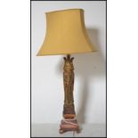 A vintage medieval style carved wooden table lamp of tall form depicting a king raised on plinth
