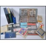 A large collection of vintage stamps FDC's, coins, cigarette cards etc to include albums of
