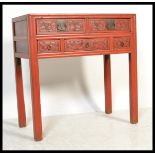 A Chinese mid Qing dynasty red lacquered three alter table, having an arrangement of five ornately