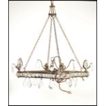 A 20th century cut glass ceiling chandelier of square form with clear faceted drops and scrolled