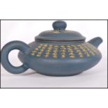 A Chinese Yi Xing teapot having a blue pottery ground with gilt Buddhist Scriptures and