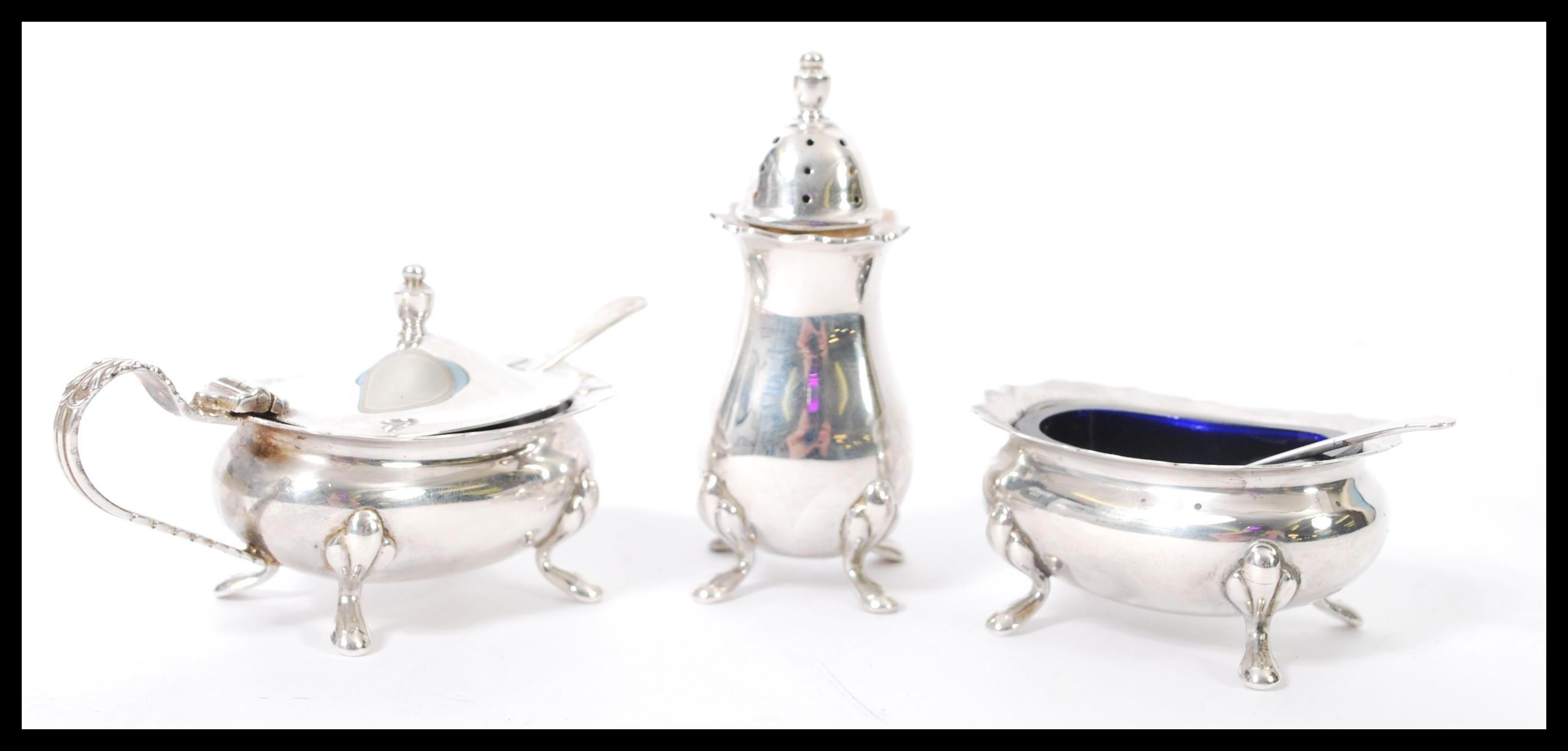 A 20th century hallmarked silver three piece condiment cruet set consisting of a tall pepperette,