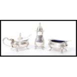 A 20th century hallmarked silver three piece condiment cruet set consisting of a tall pepperette,