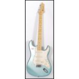 A vintage AXL Player Deluxe electric six string guitar having a metallic turquoise body with white