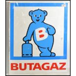 A vintage 20th century metal painted wall mounted industrial shop sign for Butagaz. White ground