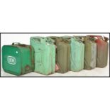 A collection of 20th century metal painted petrol gerry cans to include some with military crow's