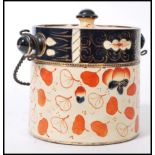 A 19th Century ceramic English Imari biscuit barrel / jar, having a twisted metal handle and