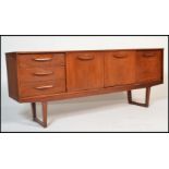 A 1970's / mid century teak wood sideboard credenza of Danish influence having angular legs with