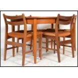 A retro 20th Century G Plan style oval extending teak wood dining table raised on shaped tapering
