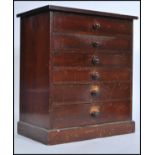 A Victorian mahogany specimin chest of drawers - table top cabinet being raised on a plinth base