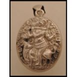 A large Indian silver white metal pendant locket featuring Kokopelli and Indian fertility God