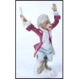 A 19th century Dresden / Meissen interest porcelain figurine of a Monkey band conductor with blue