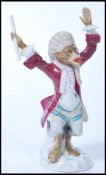 A 19th century Dresden / Meissen interest porcelain figurine of a Monkey band conductor with blue