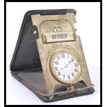 A fantastic vintage early 20th century travelling clock and desk calendar compendium featuring an