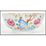 An 18th century small Cantonese Chinese ceramic bowl having hand painted floral spray with trees