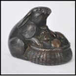 A 19th century Victorian cold painted bronze lead model figurine / paperweight of a hare peering