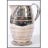 A 19th Century silver plated water jug with copper accents and banded decoration, with a