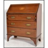 An Edwardian mahogany inlaid bureau desk having an appointed interior set within and with chest of