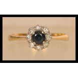 An 18ct gold diamond and sapphire ring having a central sapphire with a halo of diamonds. Weighs 2.9
