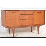 A retro 20th Century teak wood Danish inspired sideboard / Credenza, having a central bank of