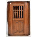 A 19th century Carved oak country hanging corner cabinet. Twin panel door being decoratively pierced