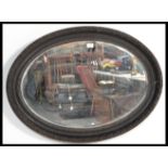 A 19th century oval bevelled glass mirror, in a pa