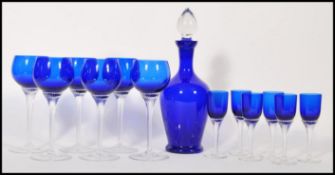 A Bristol Blue style blue glass decanter with fitted stopper together with a set of six matching