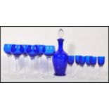 A Bristol Blue style blue glass decanter with fitted stopper together with a set of six matching