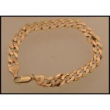 A hallmarked 9ct gold curb link bracelet chain having a lobster claw clasp. Weighs 10.3 grams.