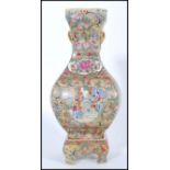 A Chinese Qianlong mark vase on stand. The bulbous square vase having hand painted scenes of court
