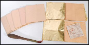 A collection of eight books of Gold leaf sheets together with with a tool for the application of