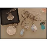 A selection of silver pendant necklaces to include a stamped 925 oval pendant with mother of pearl