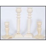 A collection of 4 19th century Ivory carved candlesticks to include a large pair with turned stems