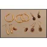 A selection of gold and yellow metal earrings to include a pair of stamped 375 gold hoop earrings, a