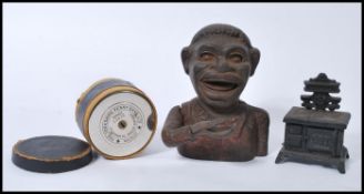 A group of vintage 20th century cast iron money banks / boxes to include a Jolly Nigger Bank, a